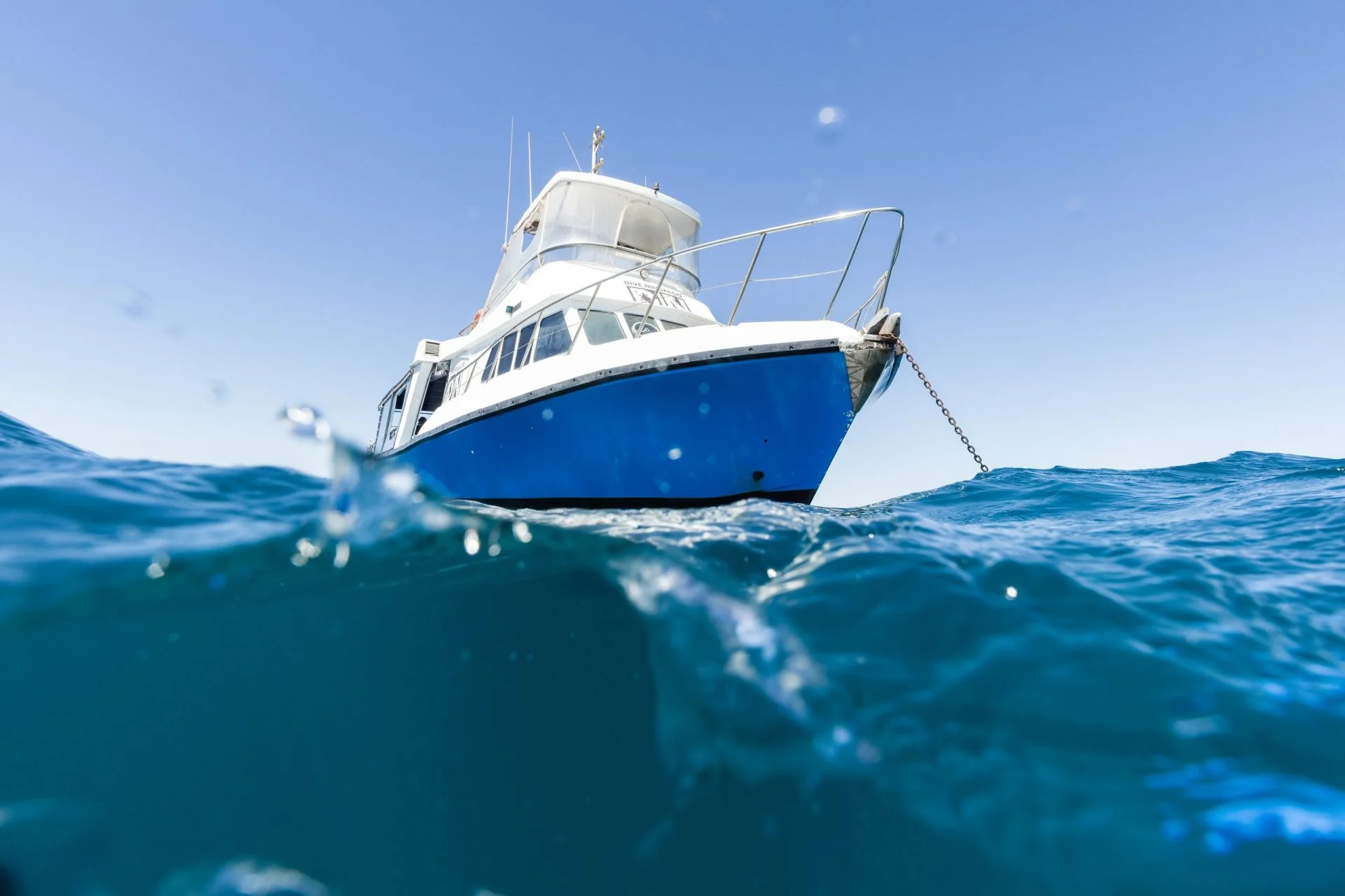 Dive Ningaloo boat on a mooring under a blue sky