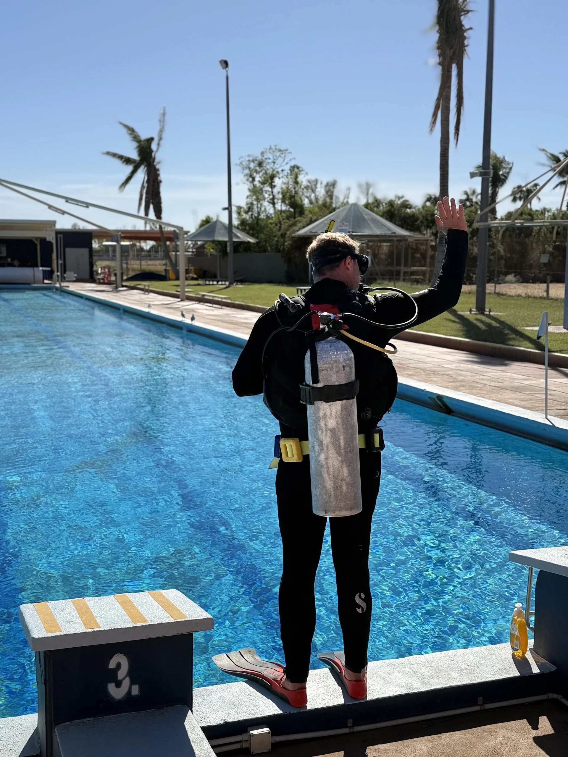 Student diver getting ready to giant stride into the pool